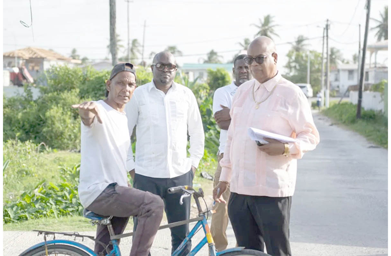 Minister of Public Works, Bishop Juan Edghill engaging a resident in Annandale North
