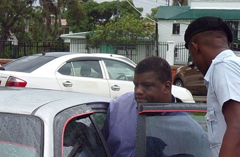 Hilton Lilley entering a police vehicle