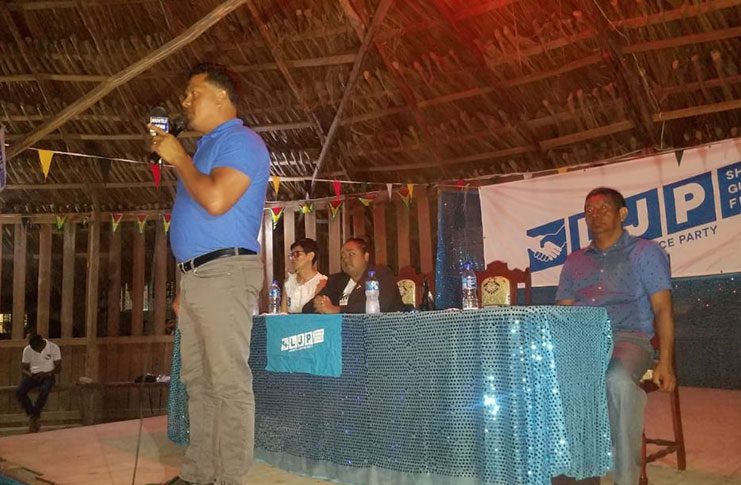 LJP Presidential Candidate, Lennox Shuman, speaking at the party’s final public meeting. [From left] Seated are overseas-based party supporter Yvonne Flores; TNM Presidential Candidate, Asha Kissoon; and LJP VP, John Flores
