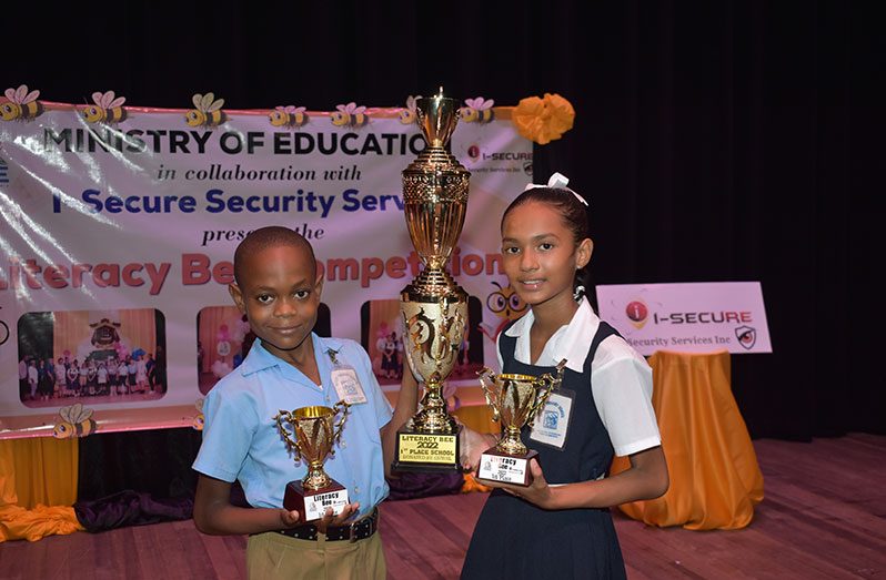 Antwon Henry (left) and Angelina Deonarine successfully defended Ketley Primary school’s title as champions in the MoE Literacy Bee competition (Elvin Croker photo)