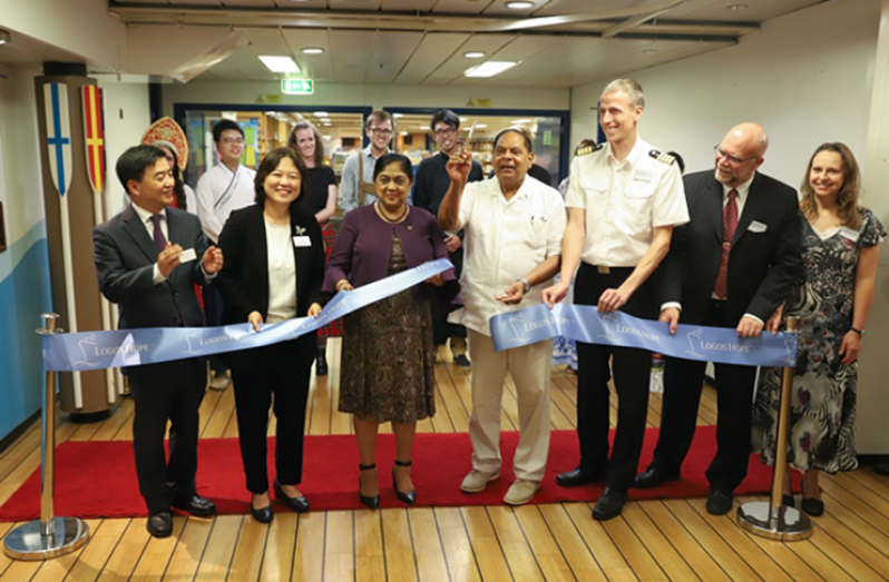 Prime Minister Moses Nagamootoo and wife, Sita Nagamootoo, joined Captain of the Logos Hope, Samuel Hils, and Director of the Logos Hope, Pil-Hun Park, and his wife, to cut the ribbon to open officially, the Logos Hope Book Fair