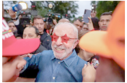 Brazilian President Luiz Inacio ‘Lula’ da Silva greets supporters in Sao Paulo, Brazil, on October 25 (Tuane Fernandes/Reuters)