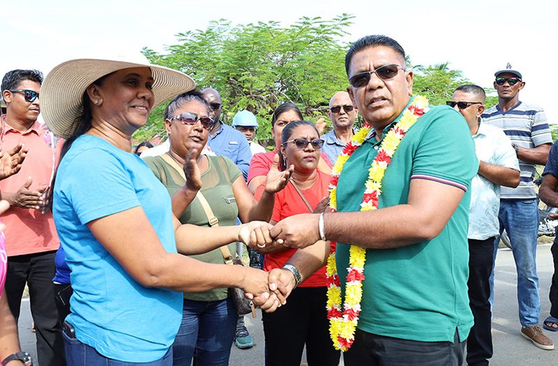 Agriculture Minister, Zulfikar Mustapha, hands over the keys to the two mini excavators to the Black Bush Polder Chairperson