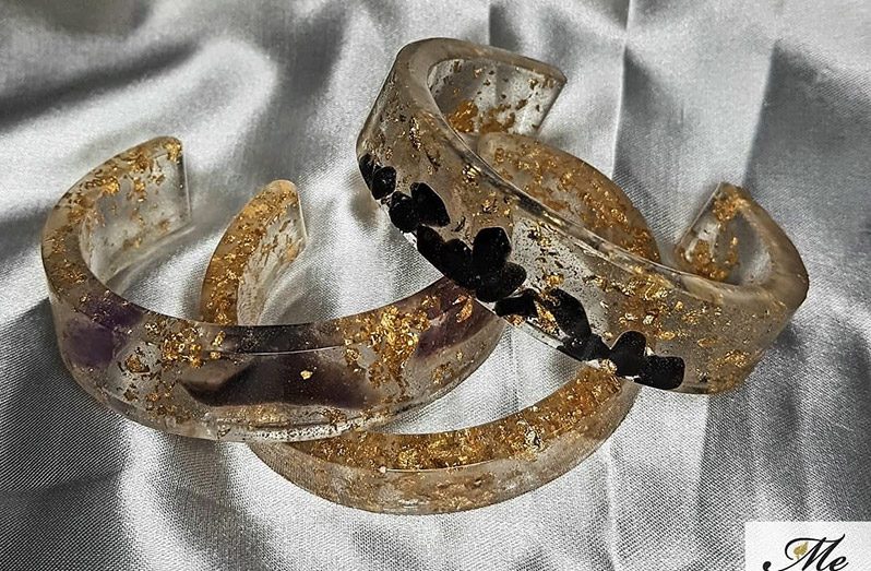 Handmade gemstone-embedded cuffs made by Matoya Grant