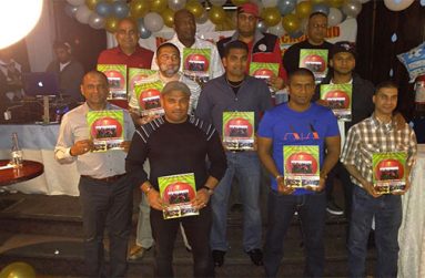 HACC members, including president Narchand ‘Archie’ Mohan (extreme left, back row) display the club’s latest cricket magazine.