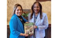 Senior Vice-President for International Business at the Greater Miami Chamber of Commerce, Liane Ventura, receives a copy of Caribbean Business & Travel from the Chief Executive Consultant of Carigold Signature, Sandra Ann Baptiste