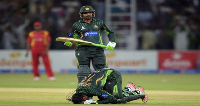 Shoaib Malik celebrates his ton by kissing the turf he made it on at home.