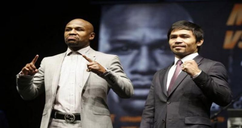 Eleven-time, five-division world boxing champion Floyd ‘Money’ Mayweather (L) and eight-division world champion Manny ‘Pac-Man’ Pacquiao pose at a news conference ahead of their upcoming bout, in Los Angeles. (Credit: REUTERS/Lucy Nicholson)