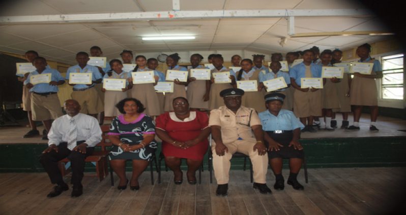 Seated in front row are Pastor Derek Anderson, Head Mistress Kamal Persaud,  Regional Education Officer Penelope Mackintosh, Commander Stephen Mansell and trainer Woman Lance Corporal Lovell with students of Vreed-en-Hoop Secondary School displaying their certificates last Friday