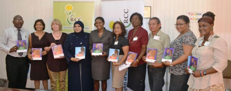 Minister of Human Services and Social Security, Dr. Jennifer Webster, with UNICEF Representative for Guyana and Suriname, Marianne Flach, Chairperson of Rights of the Child Commission, Aleema Nasir and other staff of the Commission, holding copies of the booklets