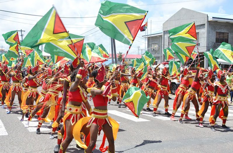 FLASHBACK:  Guyanese revelers doing what they do best, ‘repping 592’ and the Golden Arrowhead, the national flag on Mashramani day