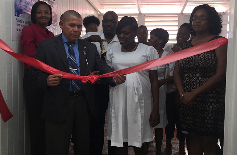 Public Health Minister Dr. George Norton cutting the ribbon to officially declare open the maternity unit at the Port Mourant Hospital
