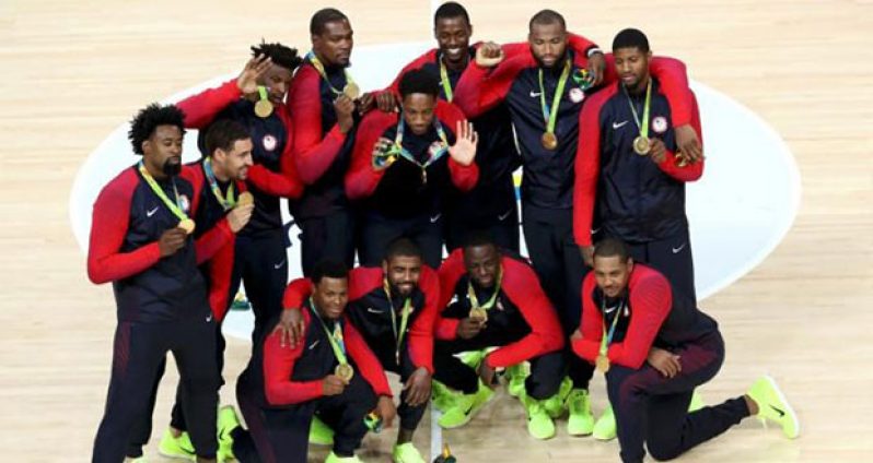 United States players pose with their gold medals during the presentation ceremony for men's basketball. REUTERS/Antonio Bronic