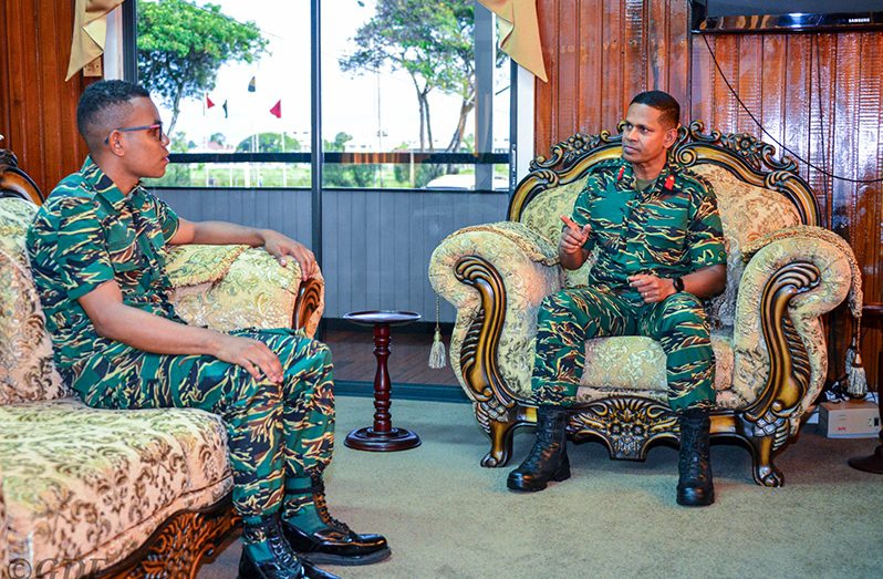 Chief-of-Staff (ag), Colonel Omar Khan (right) and Lance Corporal Shamar Garraway during their meeting on Monday