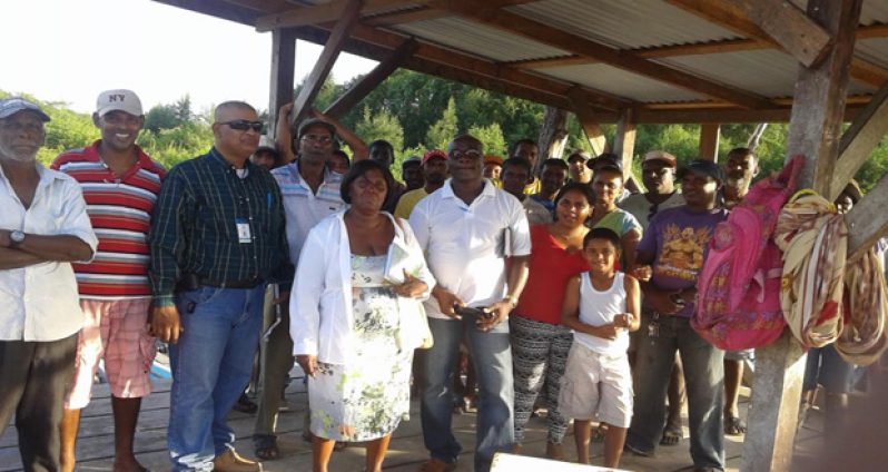 Special Assistant to Prime Minister Moses Nagamootoo, Gobin Harbhajan, and Liason Officer to the Office of the President, Barbara Pilgrim, with some residents and fisher folk of Albion, East Berbice