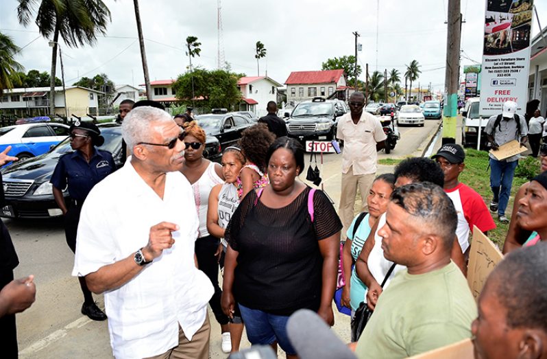 President David Granger meeting with security guards who have  not been paid since December 2017 