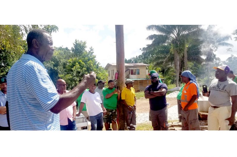 GBGWU General Secretary, Lincoln Lewis, (left) speaking with BCGI workers and community residents