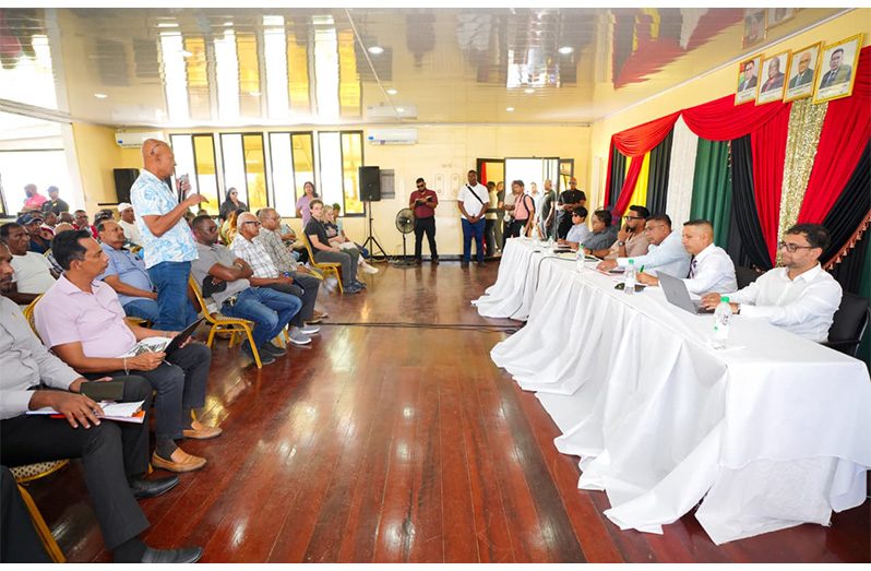 President Ali and members of his Cabinet listens attentively as a rice farmer makes a point