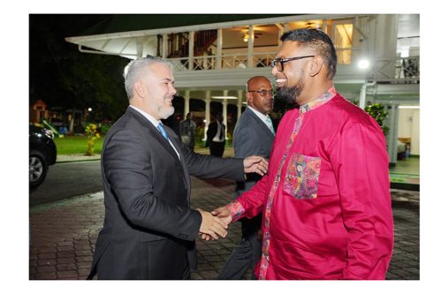 Former President of Colombia, Ivan Duque, greets President Irfaan Ali at State House (Photo: Office of the President/February 13, 2023)