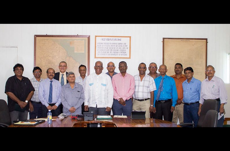 Minister of Finance Winston Jordan, Junior Finance Minister, Jaipaul Sharma and Bank of Guyana Governor, Dr Gobind Ganga pose with representatives of Berbice Business Chambers