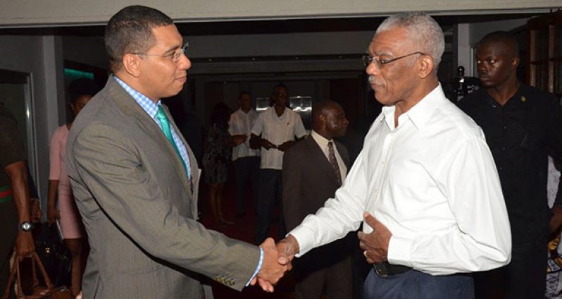 President David Granger and Prime Minister Andrew Holness greeting each other at the Pegasus Hotel