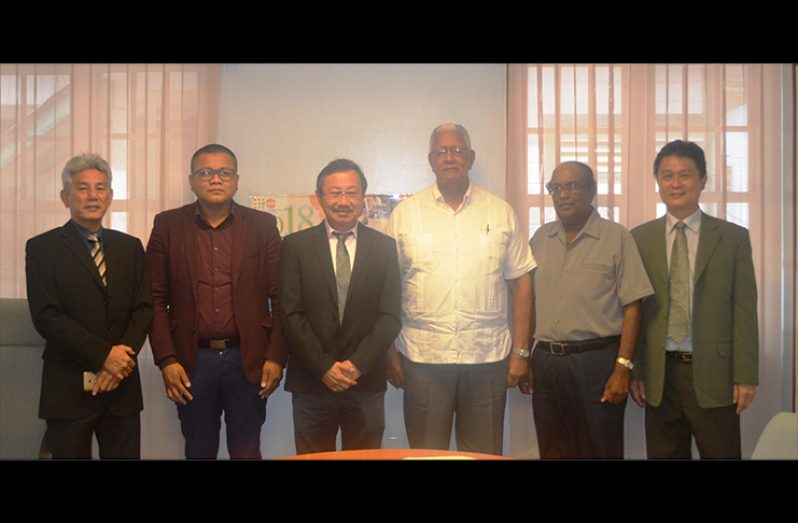 Minister of Agriculture Noel Holder(fourth,left) with the team and NAREI CEO, Dr Oudho Homenauth(second,right)