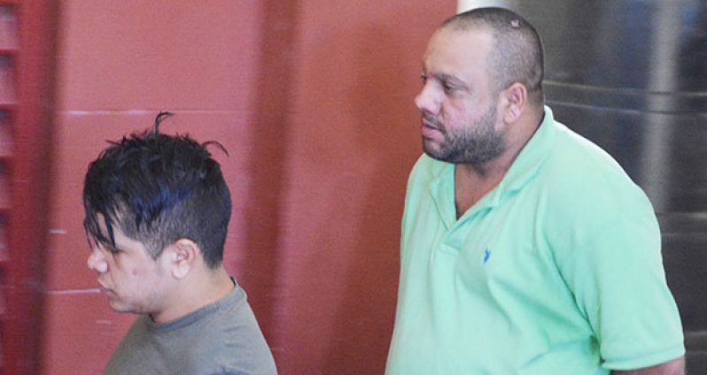 Brazilian national Joaquin Fillio (grey jersey) and Mario Figueroa (green jersey) after their court appearance