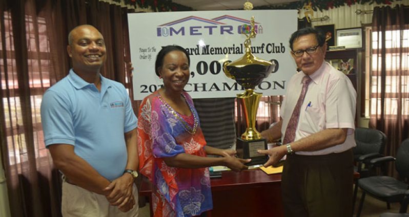 In this Cullen Bess-Nelson photo, Metro’s CEO Avia Maria Lindie (second left) presents Justice Cecil Kennard with the trophy for the winning horse of the feature event, while at extreme left is Metro’s manager Bernard Ramsaroop.