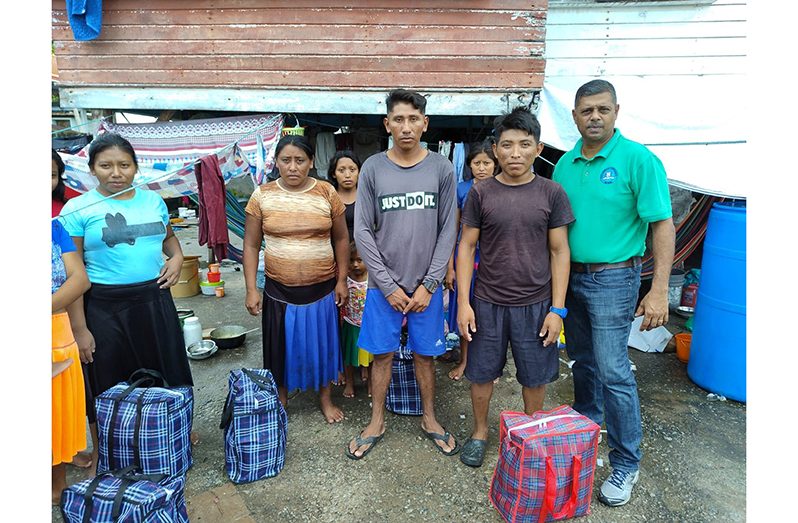 Some of the migrants showing the hampers they received