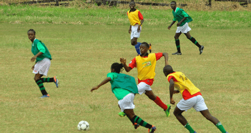 Flashback! Preliminary round action in this year’s Milo/Petra Organisation Under-20 Inter-School football championships, between Lodge Secondary (green bib) and St Winefride at the Ministry of Education ground.