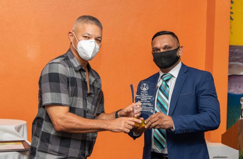 Minister Bharrat presenting the “Top Gold Achiever’s award to GGDMA’s Kevin Jeffrey