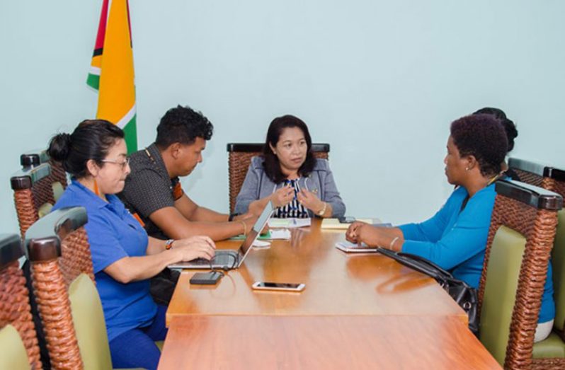 Minister of State, Dawn Hastings-Williams engaging Toshao of Chinese Landing, Orin Fernandes and members of the village council, and Rights Coordinator at the Amerindian Peoples’ Association (APA), Laura George