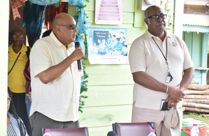 Minister of Natural Resources, Hon. Raphael Trotman addresses residents of Mahdia during Wednesday's mining Lottery. Looking on is Commissioner of the Guyana Geology and Mines Commission, Newell Dennison.