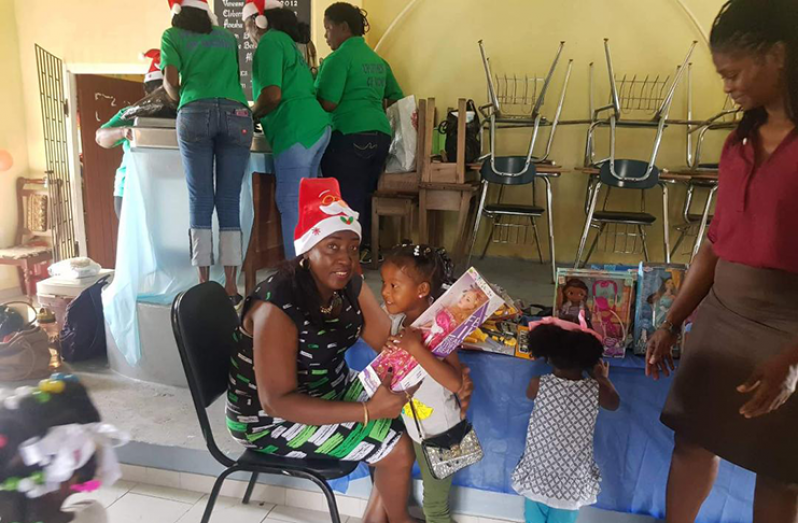 Minister Valarie Yearwood presenting this pupil of Moblissa with a gift