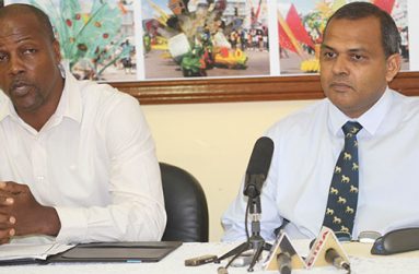 Minister of Sport Dr Frank Anthony (right) addresses members of the media yesterday at his Main Street office. At left is the Permanent Secretary Alfred King (Photo by Sonell Nelson)