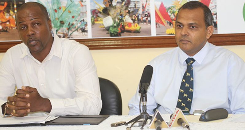 Minister of Sport Dr Frank Anthony (right) addresses members of the media yesterday at his Main Street office. At left is the Permanent Secretary Alfred King (Photo by Sonell Nelson)