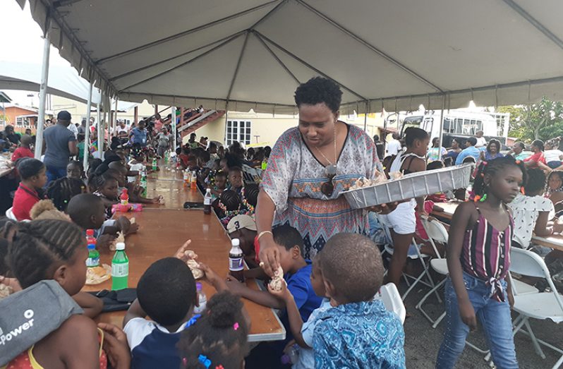 Minister within the Ministry of Communities, the Honourable Annette Ferguson distributing goodies at the Christmas party on Sunday afternoon