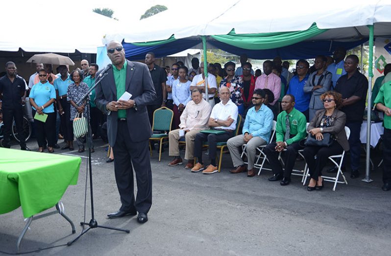 Minister of State Joseph Harmon, surrounded by his ministerial colleagues and other officials, addresses the opening of the public day event at the Square of the Revolution (Samuel Maughn photo)