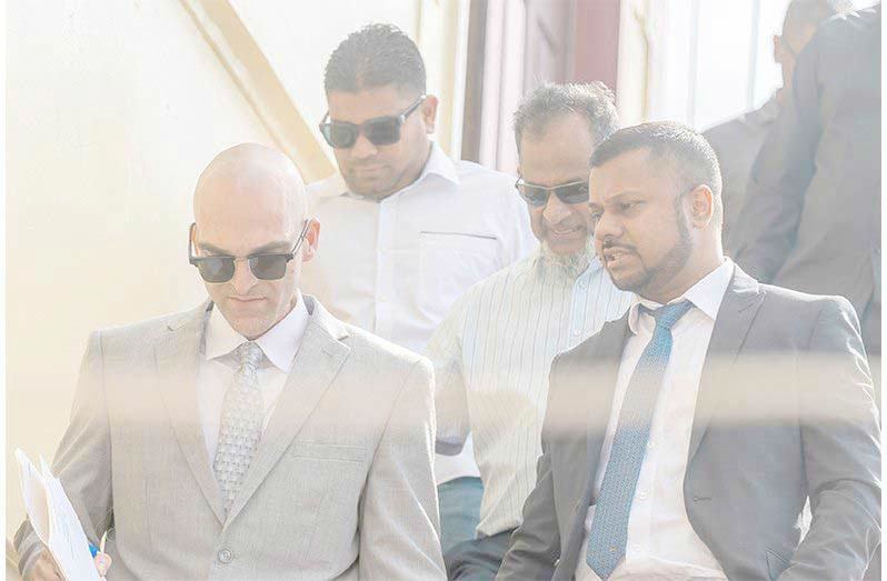 Nazar and Azruddin Mohamed pictured with their attorneys, Siand Dhurjon and Damien DaSilva at the Georgetown Magistrates’ Courts (Delano Williams photo)