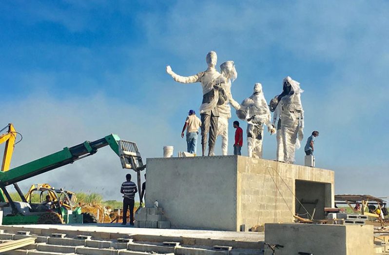 Workers busy mounting the statues