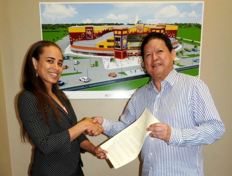 Emerald Wallis of Director of Maxine Management Services,and MovieTowne CEO , Derek Chin following the signing of the agreement.