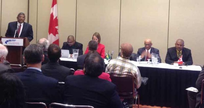 Dr. Nanda Gopaul, Minister of Labour, delivering his remarks at the Guyana Mining Day held at the Metro Toronto Convention Centre, Canada.   Seated from left are Mr. Bobby Gossai, Senior Policy Analyst, Ministry of Natural Resources and the Environment; Her Excellency, Dr. Nicole Giles, High Commissioner of Canada to Guyana; His Excellency, Harry Narine Nawbatt, High Commissioner of Guyana to Canada; and Mr. Rickford Vieira, Commissioner, Guyana Geology and Mines Commission (GGMC)