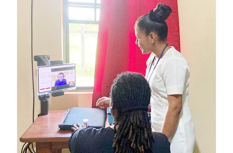 Marishah Singh, a Region Nine community health worker, communicating with a doctor at the GPHC