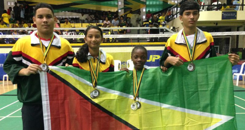 The Guyana medal winners proudly display their medals and national flag at the Caribbean Regional Badminton Championships. From left are Jonathan Mangre, Priyanna Ramdhani, Abosaide Cadogan and Narayan Ramdhani.