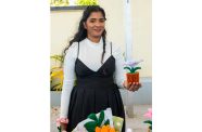 Falisha Mohamed displays one of her handmade flowers (Elton John photos)