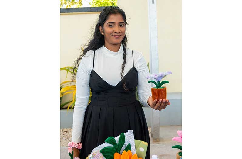 Falisha Mohamed displays one of her handmade flowers (Elton John photos)