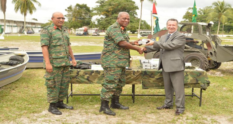 Guyana Defence Force Chief-of-Staff, Brigadier Mark Phillips receives the military equipment from Brazilian
Ambassador to Guyana, Lineu Pupo De Paula, while another officer looks on (GDF photo)