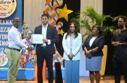 Minister of Culture, Youth and Sport, Charles Ramson Jr and members from the ministry presenting the grant certificate to one of the new recipients