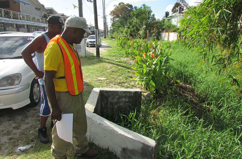 MPI’s Community Coordinator Neilson McKenzie (with reflective vest), inspects the Lamaha Canal during a recent walkabout in Newtown, Kitty. The Lamaha Canal is one of several spots identified for major works in the coming weeks