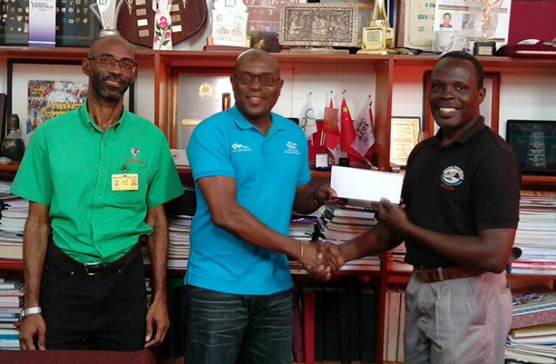 In this photo GOA assistant secretary/treasurer Dion Nurse (right) hands over the cheque to Ninvalle. Looking on is GOA treasurer Garfield Wilshire.
